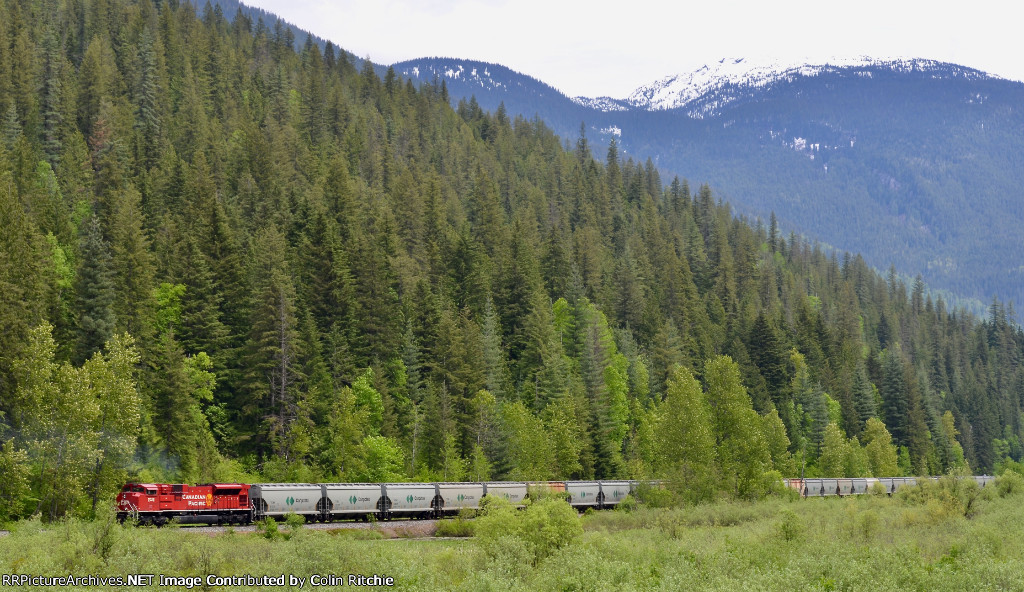 CP 7028, trailing DPU on an empty E/B unit potash train. Eagle Pass Mtn in the background